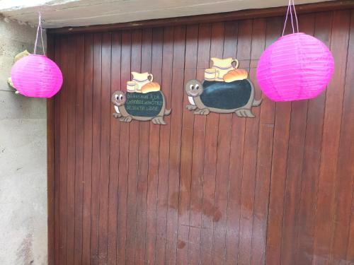 a door with two seals and a sign on it at Chambre d'hôtes Se Sentir Libre Châtaigne in Crozant