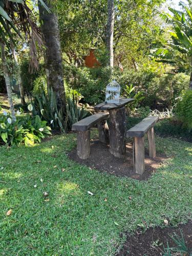 a picnic table and bench in a park at Eco Villas Tambor Tucanes in Tambor