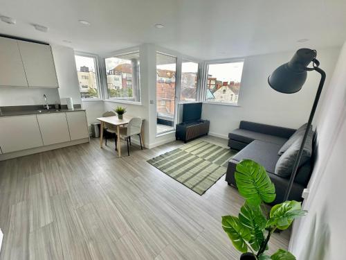 a living room with a couch and a table at Modern Flat in Leigh Broadway in Leigh-on-Sea