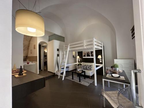 a room with a loft bed and a living room at CasaCastellett in Modica