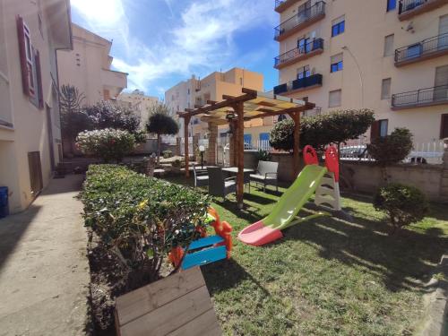 a playground with a swing set in a yard at Il Sogno di Giò in Alghero