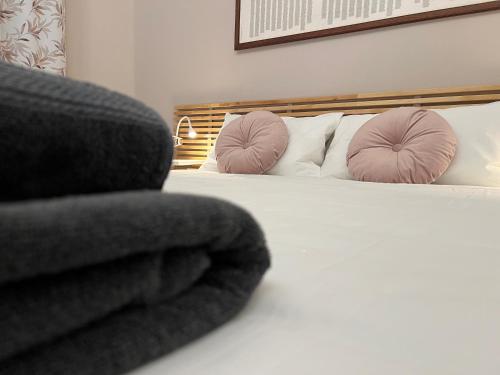 a bedroom with a bed with pink pillows at Mercadante Suite Central City in Milan