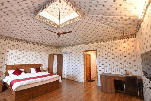 a bedroom with a bed and a ceiling fan at Sound of Forest in Āmbavna