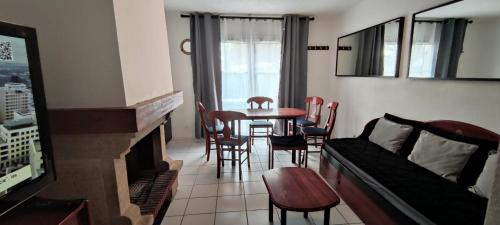 a living room with a couch and a table and chairs at Les maisons de Port Guillaume - maeva Home - Maison 3 Pièces 6 Personnes Sélection MAE-2279 in Dives-sur-Mer