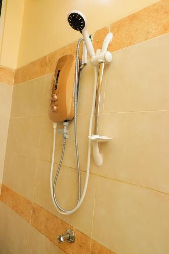 a shower head on a wall in a bathroom at The Modern loft in Nairobi