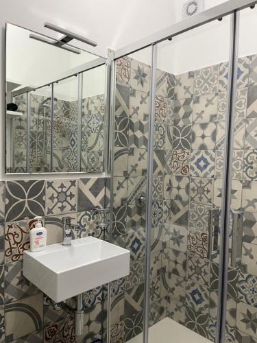 a bathroom with a sink and a shower at Andrea&Vittoria Apartments - Borgo 84 - Marzamemi in Marzamemi