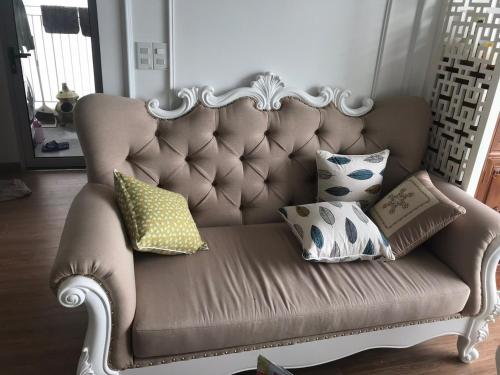 a couch with pillows on it in a living room at S1-05A11A-Sapphire Hạ Long in Ha Long
