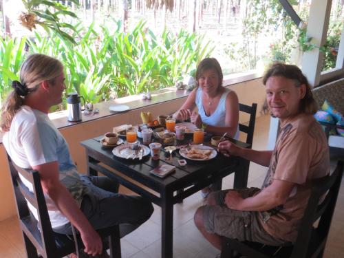 a group of people sitting around a table eating food at Manora Garden in Phangnga