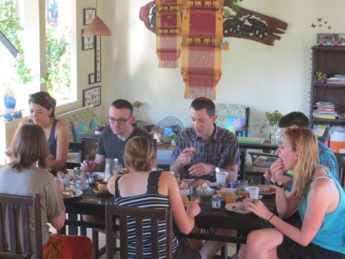 a group of people sitting at a table in a restaurant at Manora Garden in Phangnga