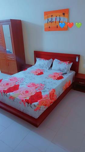 a bedroom with a bed with red roses on it at BEST VILLA in Darou Rhamane