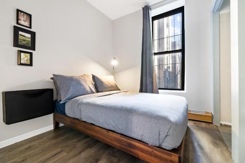 a bedroom with a bed and a window at Step inside Central Living in Times Square in New York