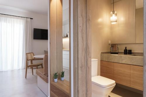 a small bathroom with a toilet and a table at enδόtera chios apartments in Chios