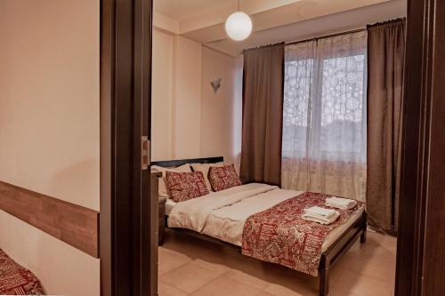 a small bedroom with a bed and a window at 2-room Apartment NFT Gudauri Penta 405 in Gudauri