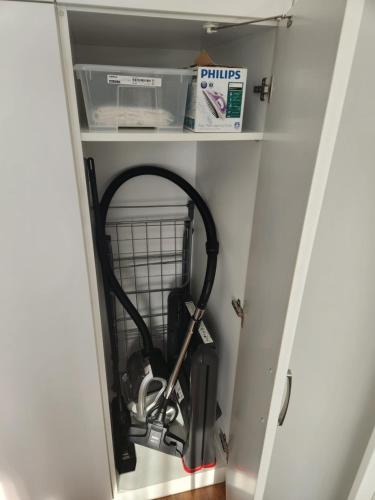 a closet with a vacuum cleaner in it at Słoneczny Apartament Warsaw Spire in Warsaw
