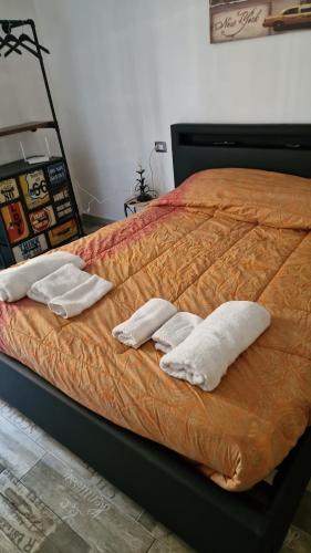 a bed with two white pillows on top of it at Nico&Francy holiday in Iglesias