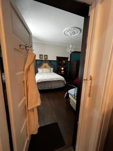 ein Schlafzimmer mit einem Bett und einen Flur mit einer Tür in der Unterkunft Bed and Breakfast Hearts Desire in Raton