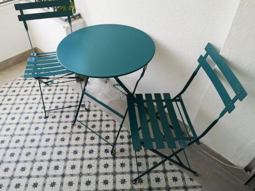 a blue table and two chairs sitting next to a wall at Rincón del Atlántico in Isla Cristina