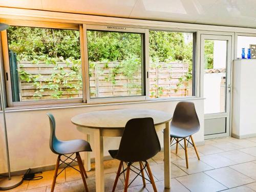 a table and chairs in a kitchen with windows at Antibes Port de Salis Appart 3p in Antibes