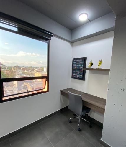 an office with a window and a desk and a desk chair at Apartamento Loft Bogotá in Bogotá