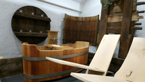 a bathroom with a wooden tub and a mirror at Haloze na dlani - Haloze in your hand, hiša s pogledom na hribe - a house vith a view of hills in Gruškovec