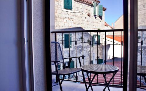 a patio with a table and chairs on a balcony at Galeria Valeria Seaside Downtown - MAG Quaint & Elegant Boutique Hotels in Split