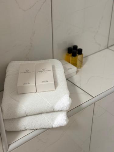 a pile of towels sitting on a shelf in a bathroom at Estrada Apartment in Sarajevo