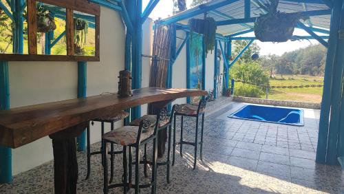 a dining room with a table and chairs and a pool at Hotel sol del lago in Guatapé