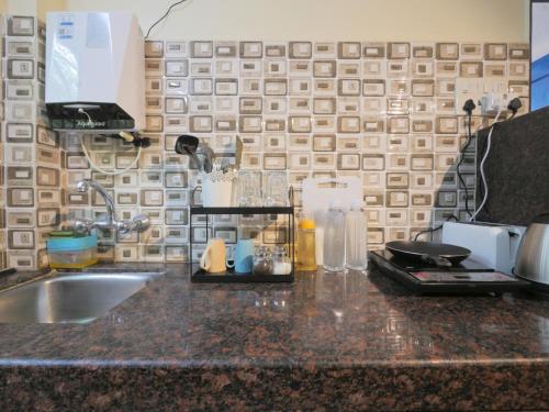 a kitchen counter top with a sink and a counter top at Ranger - Bandra West in Mumbai