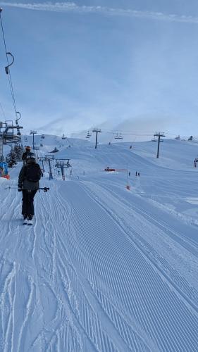a person riding a ski lift in the snow at Chalet Lè Lodzé - Pieds des pistes in La Rosière