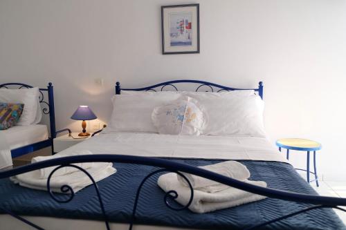 a bed with white sheets and pillows in a bedroom at Leventis Apartments in Rovies