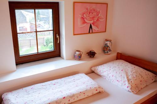 a bedroom with a bed and a window at Chalupa na Valašsku in Halenkov