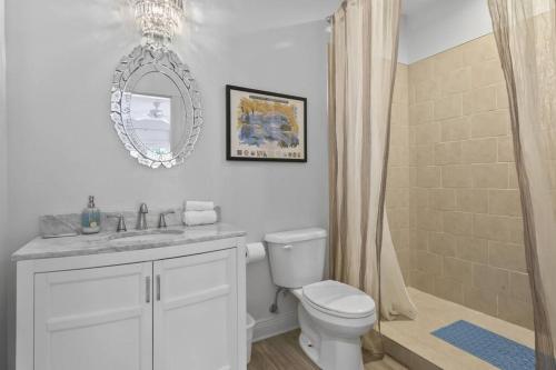 a bathroom with a toilet and a sink and a shower at Hotel Pass Christian Double Full 204 in Pass Christian