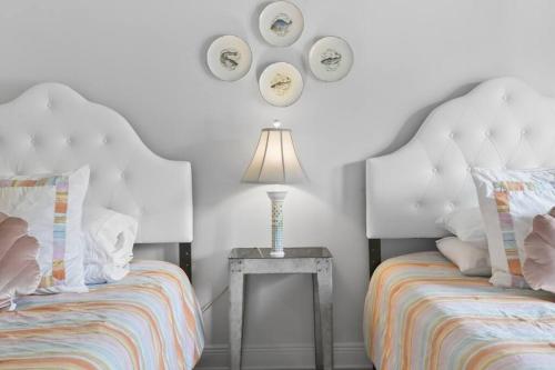 a bedroom with two beds and a table with a lamp at Hotel Pass Christian Double Full 204 in Pass Christian