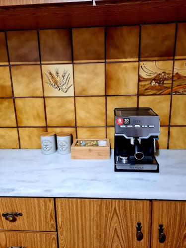 a kitchen counter with a coffee maker and two cups at City Center Luxury Spacious apt A&M in Rhodes Town