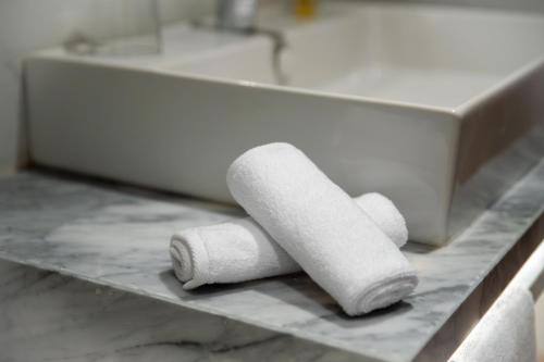 two rolls of toilet paper sitting on a bathroom counter at Dominium Palace in Agadir