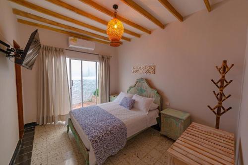 a bedroom with a bed and a window at Colonial Beach Airport Hotel in Cartagena de Indias