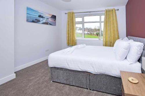 a bedroom with a large bed and a window at Lancaster House in Stoke on Trent