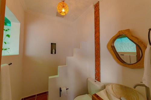 a bathroom with a staircase and a toilet and a mirror at Colonial Beach Airport Hotel in Cartagena de Indias