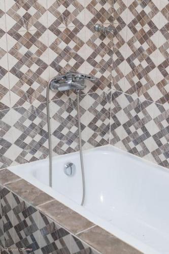 a shower in a bathroom with a white tub at Stunning 2 Bedroom Affordable pl in Kumasi