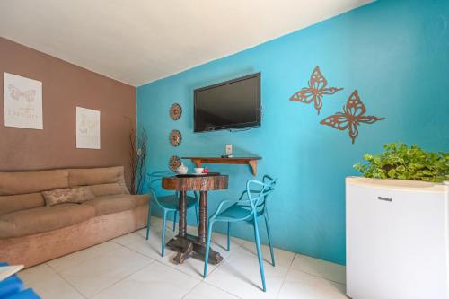 a living room with a couch and a table at Hotel Praia Do Rosa in Praia do Rosa