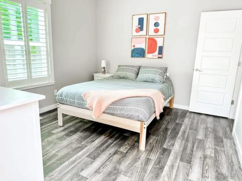 a bedroom with a bed with a wooden floor at Remodeled Downtown 3bed Home Quartz Countertops in Boise