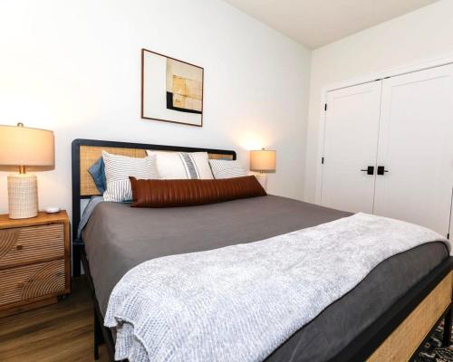 a bedroom with a large bed and two lamps at Downtown Traverse City Apartment near West Bay in Traverse City