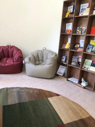 a room with two bean bag chairs and a book shelf at TUTUhouse in Cairo