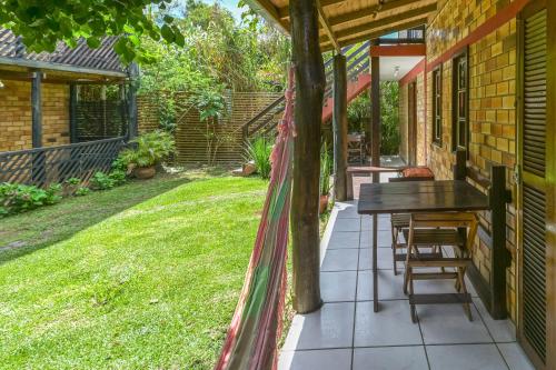 a patio with a table and chairs on a house at Hotel Praia Do Rosa in Praia do Rosa