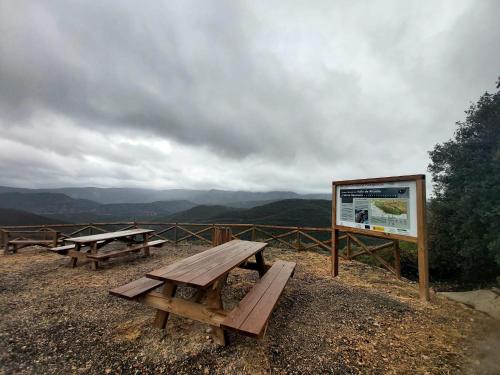 a group of picnic tables on top of a mountain at ALOJAMIENTO TURISTICO LAS SOLANERAS in Solana del Pino