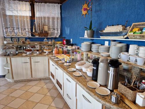 a kitchen with a counter with dishes on it at HOTEL DAIFA in Florianópolis