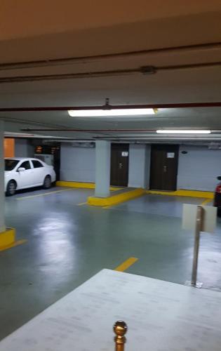 a parking garage with a white car parked in it at Verta Quraish Hotel in Jeddah