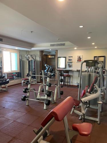 a gym with several tread machines in a room at Verta Quraish Hotel in Jeddah