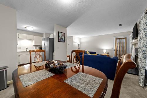 a living room with a table and a blue couch at Comfortable Greensboro Condo in Greensboro