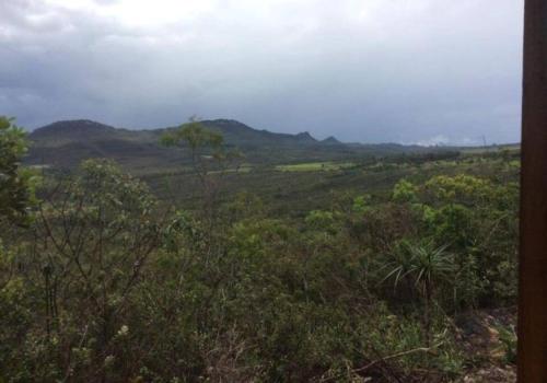 a view of a field with trees and mountains at Chalé Mirante do Vale in Piatã